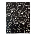 Greeting card with pattern of black daisy ghosts with white outlines on a black card background